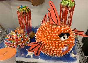 Pumpkin carved into a blowfish with a sea scape pumpkin background