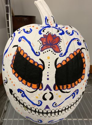 Pumpkin decorated to look like a day of the dead sugar skull
