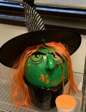 pumpkin painted to look like a witch